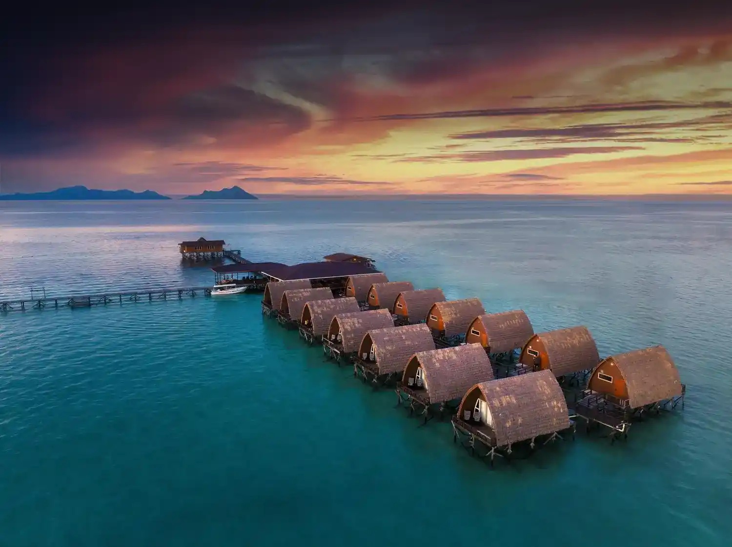 Water bungalows over the lagoon at sunrise