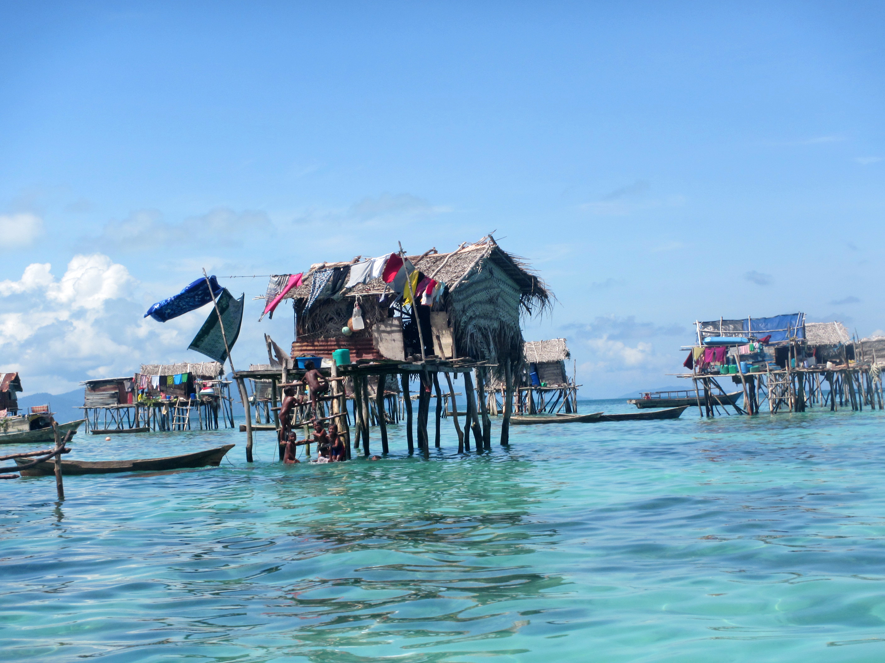 Lepa boat moored beside stilt houses at golden hour