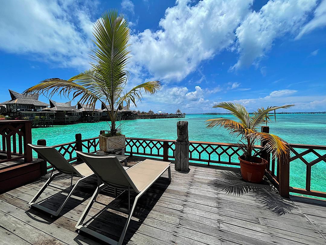 Private deck of a water bungalow at dusk