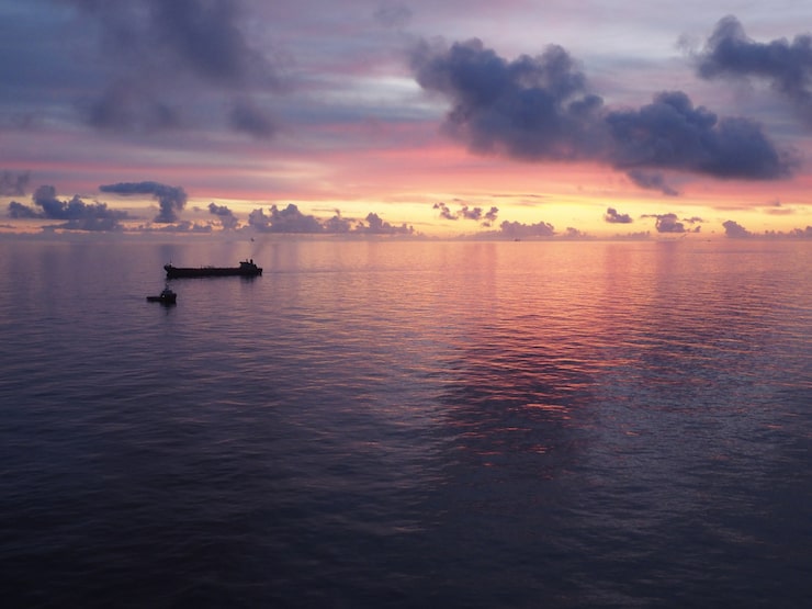 Boat heading out toward open water at dawn