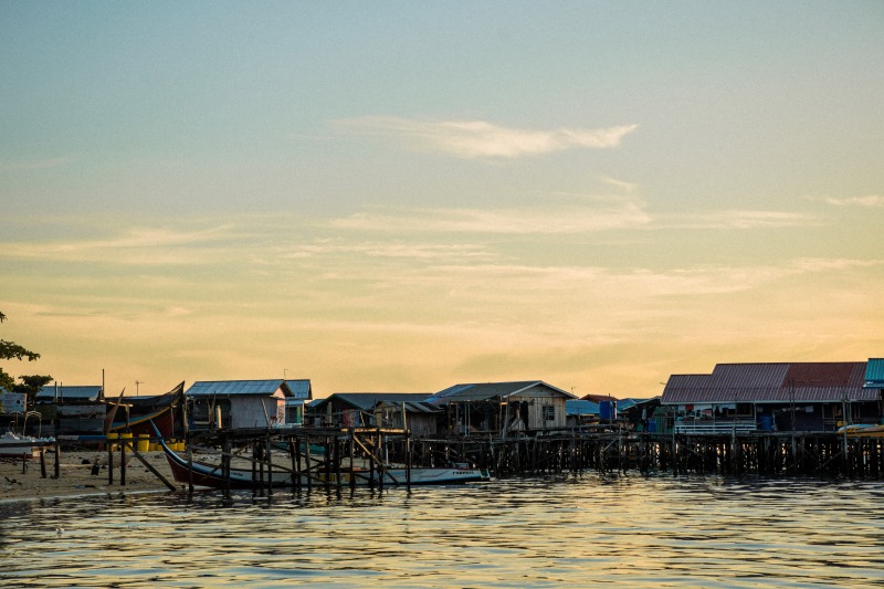 Sunset over the stilt village at the end of a dive day
