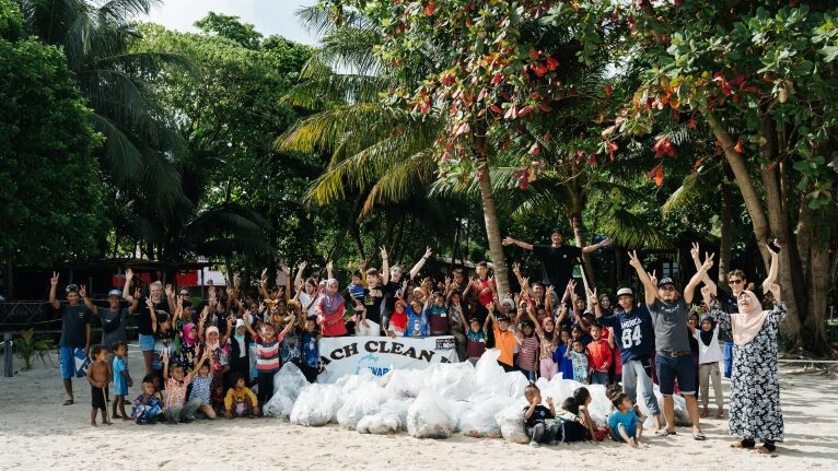 Volunteers and villagers at a beach clean-up on Mabul